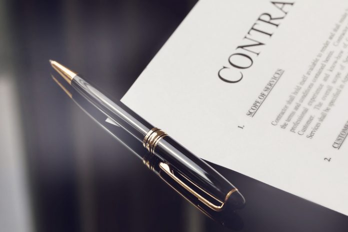 contract documents and fountain pen on black desk, business concepts