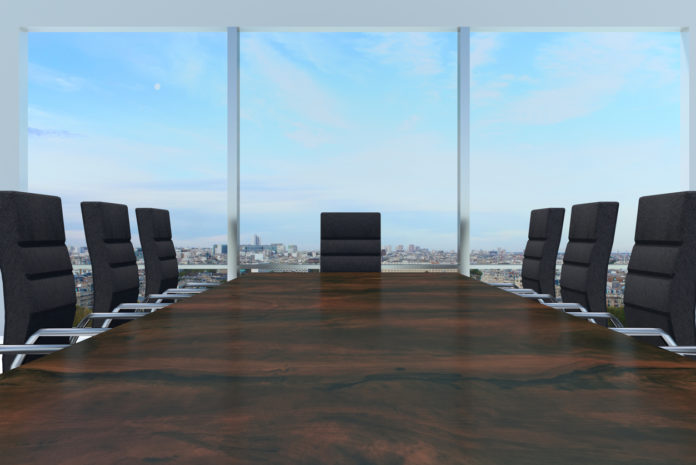 conference room with large wooden desk and skyline window