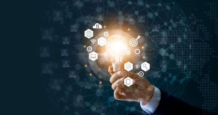 Businessman holding light bulb and new ideas of business with innovative technology network connection. Business innovation concept.