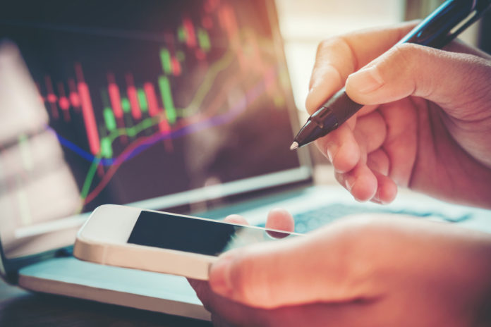 Businessman writing the trading graph of stock market
