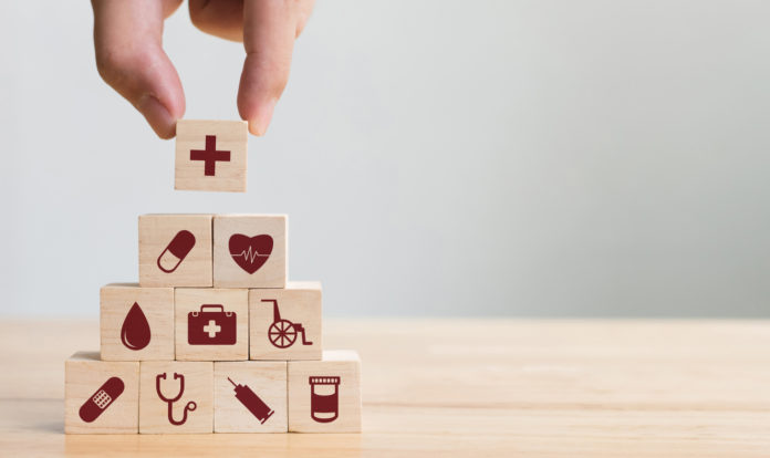Hand arranging wood block stacking with icon healthcare medical, Insurance for your health concept