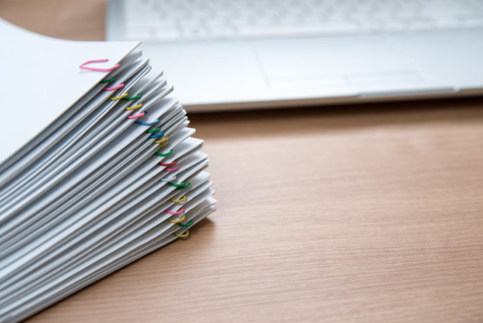 A pile of documents with copy space