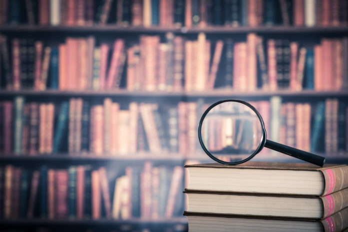 Books and magnifying glass