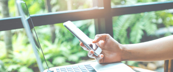 Business woman hand is using a mobile phone.
