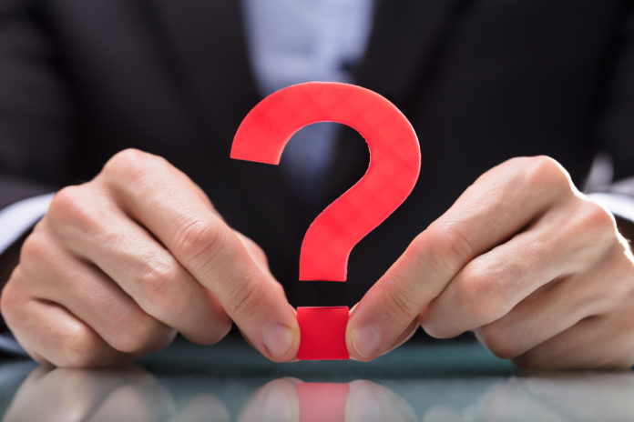 Businessperson Holding Question Mark Sign