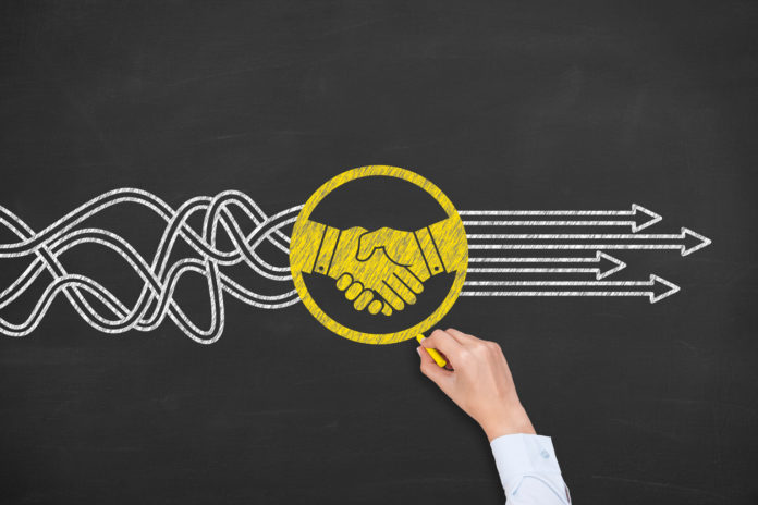 Solution Concept with Handshake on Chalkboard Background