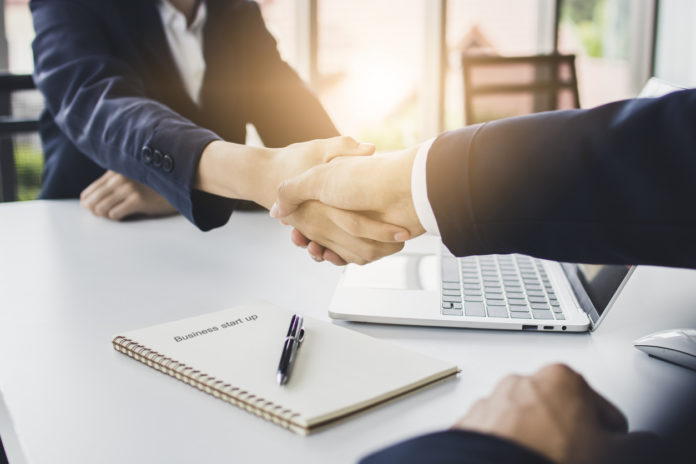 start up business people shake hands with investor before negotiating and planning to invest company together