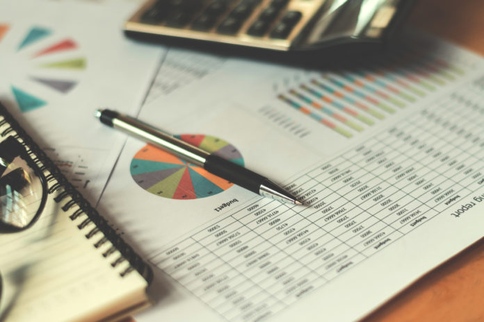 business financial concept with calculator pen and accounting report in office
