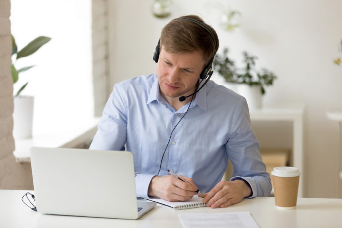 Concentrated pleasant successful male entrepreneur watching educational webinar.