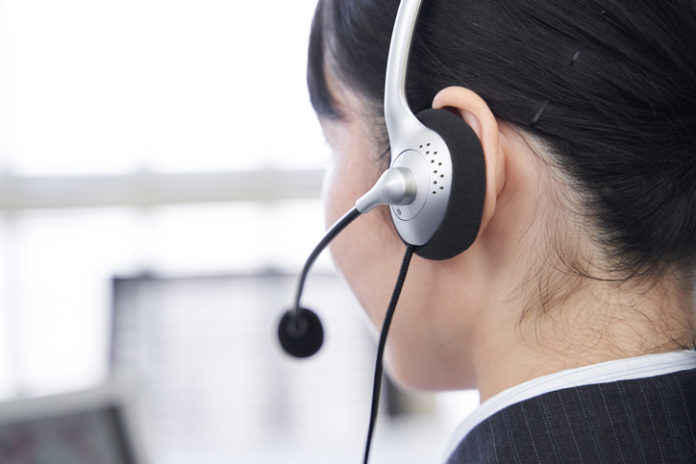 A Japanese woman in her office answering questions