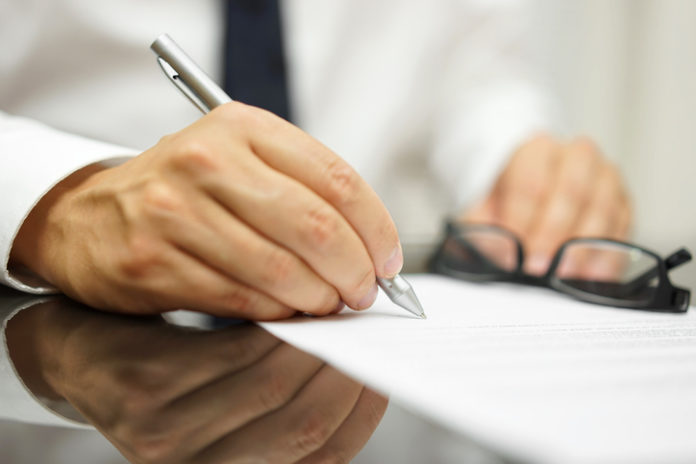 After a review of the sales contract Businessman finished deal