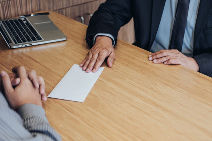 Hand of employer filing final remuneration to employee, letter of resignation, resign concept Rob Everett has resigned as CEO of the FMA.