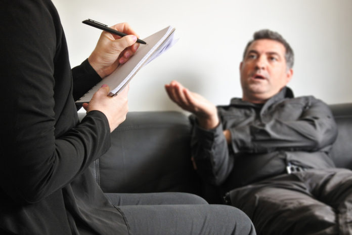 Adult man talking to a male therapist